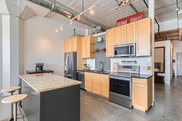 730 Stinson Blvd Unit 205, Minneapolis, MN 55413 - kitchen with appliances with stainless steel finishes, light brown cabinetry, a sink, concrete floors, and a high ceiling