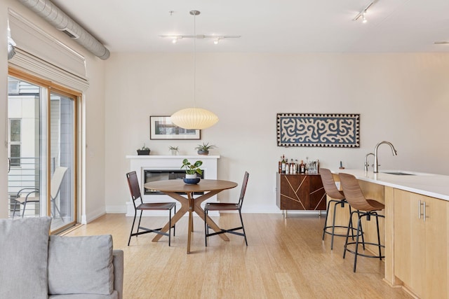 2845 Colfax Ave S Unit W202, Minneapolis, MN 55408 - dining space featuring track lighting, light wood-style floors, and baseboards