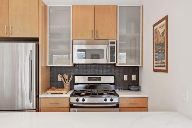 2845 Colfax Ave S Unit W202, Minneapolis, MN 55408 - kitchen featuring stainless steel appliances, backsplash, and light countertops