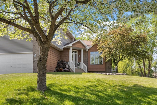 view of front of house featuring a front lawn and an attached garage