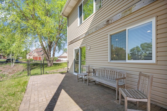 view of patio with fence and a gate