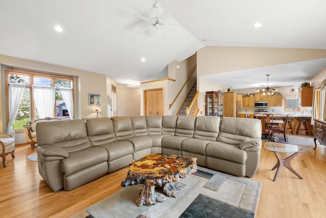 living area featuring ceiling fan, stairway, light wood finished floors, recessed lighting, and a chandelier