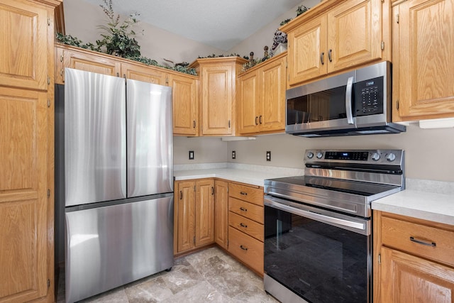 kitchen featuring stainless steel appliances and light countertops