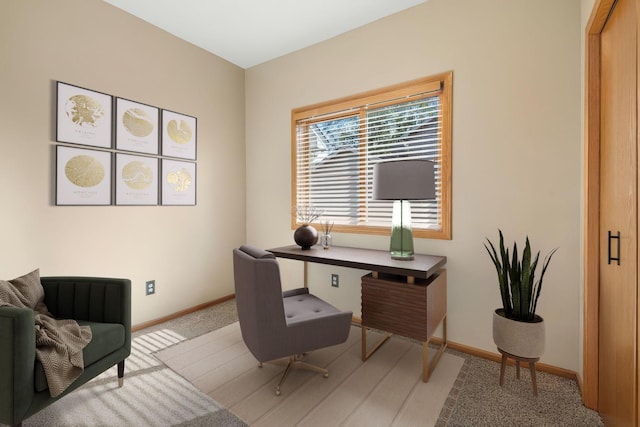 carpeted home office with baseboards