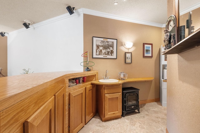 office with a sink, a textured ceiling, and ornamental molding