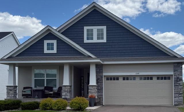 6168 Quenroe Ave NE, Otsego, MN 55330 - craftsman inspired home with covered porch, stone siding, a garage, and concrete driveway