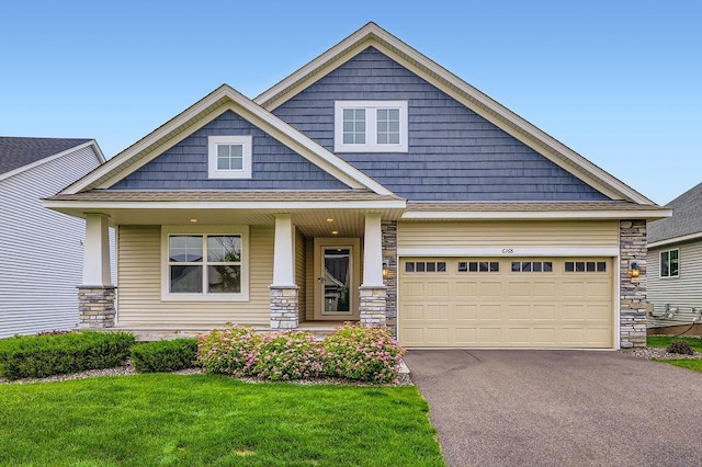 6168 Quenroe Ave NE, Otsego, MN 55330 - craftsman inspired home featuring stone siding, asphalt driveway, a front yard, a porch, and an attached garage