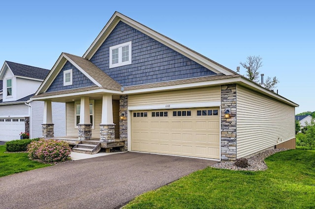 6168 Quenroe Ave NE, Otsego, MN 55330 - craftsman-style house featuring driveway, a porch, stone siding, and an attached garage