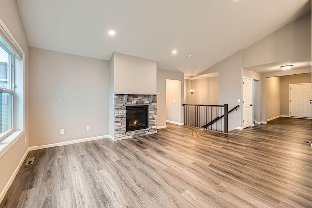 6168 Quenroe Ave NE, Otsego, MN 55330 - unfurnished living room with lofted ceiling, healthy amount of natural light, wood finished floors, and recessed lighting