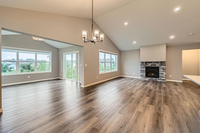 6168 Quenroe Ave NE, Otsego, MN 55330 - unfurnished living room featuring dark wood-style floors, a chandelier, a stone fireplace, recessed lighting, and high vaulted ceiling