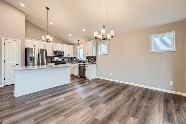 6168 Quenroe Ave NE, Otsego, MN 55330 - kitchen featuring appliances with stainless steel finishes, a chandelier, tasteful backsplash, light countertops, and recessed lighting