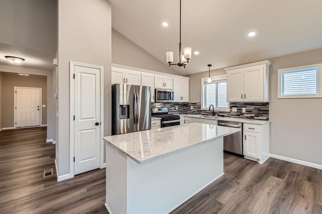 6168 Quenroe Ave NE, Otsego, MN 55330 - kitchen with stainless steel appliances, white cabinets, tasteful backsplash, a center island, and a chandelier