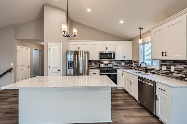 6168 Quenroe Ave NE, Otsego, MN 55330 - kitchen with appliances with stainless steel finishes, vaulted ceiling, a kitchen island, white cabinetry, and dark wood-style floors