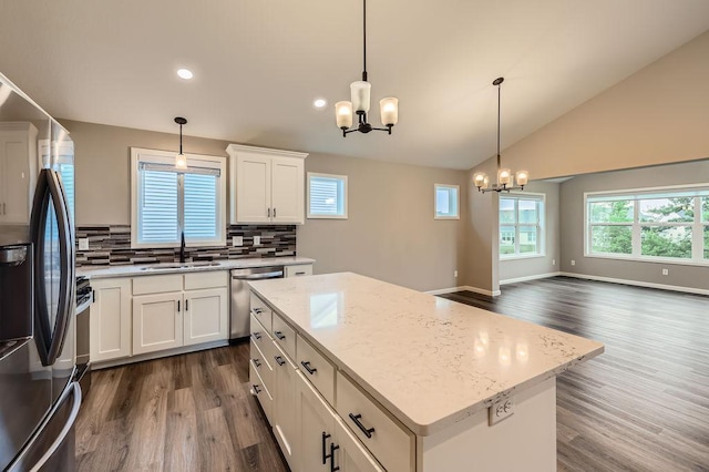 6168 Quenroe Ave NE, Otsego, MN 55330 - kitchen with stainless steel appliances, a chandelier, dark wood-style flooring, tasteful backsplash, and lofted ceiling
