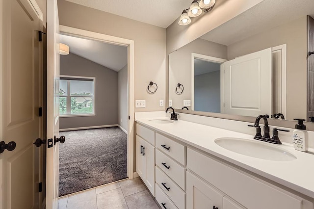 6168 Quenroe Ave NE, Otsego, MN 55330 - full bathroom with double vanity, vaulted ceiling, and tile patterned floors