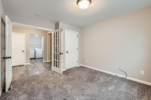 6168 Quenroe Ave NE, Otsego, MN 55330 - unfurnished bedroom with separate washer and dryer, carpet floors, a textured ceiling, and french doors