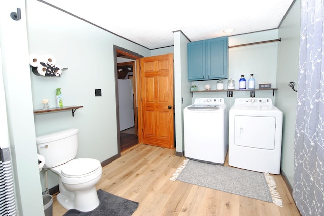 washroom with washing machine and dryer, light wood-style floors, recessed lighting, and baseboards