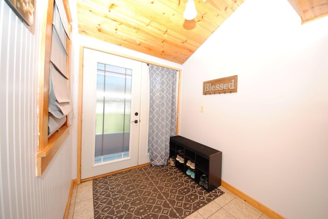 doorway featuring tile patterned floors, vaulted ceiling, wood ceiling, and baseboards