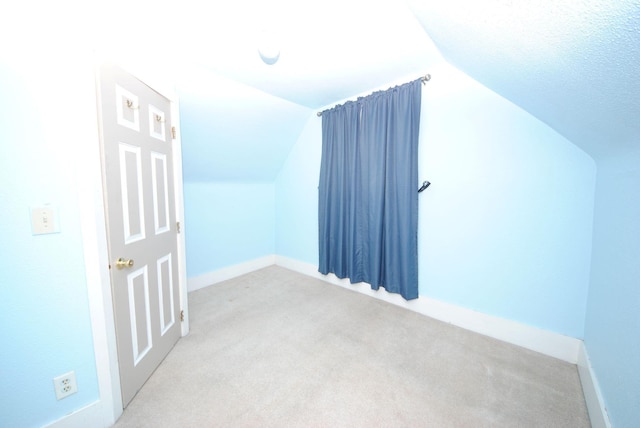 additional living space with lofted ceiling, carpet, and baseboards