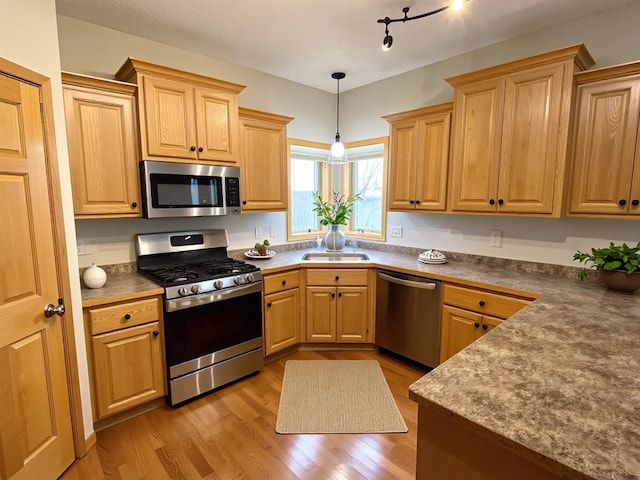2607 226th Ln NW, Oak Grove, MN 55005 - kitchen with appliances with stainless steel finishes, light wood-style floors, a sink, pendant lighting, and light brown cabinets