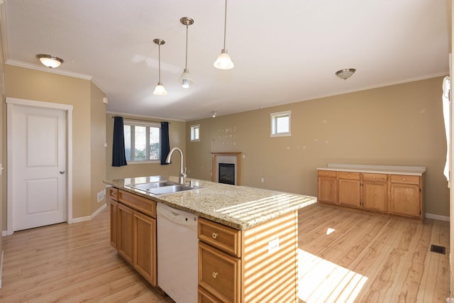 kitchen with dishwasher, a sink, light wood-style flooring, a glass covered fireplace, and baseboards