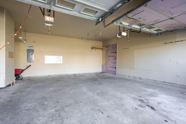 garage featuring a garage door opener and electric panel