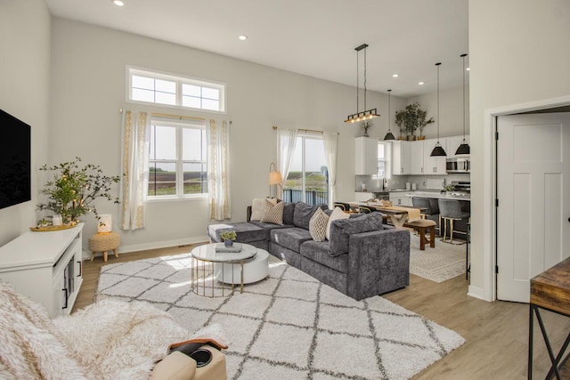 18122 Garland Path, Lakeville, MN 55044 - living area featuring light wood finished floors, a high ceiling, plenty of natural light, recessed lighting, and baseboards