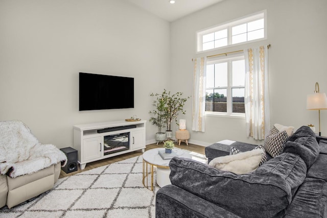 18122 Garland Path, Lakeville, MN 55044 - living area featuring light wood-type flooring, baseboards, a towering ceiling, and recessed lighting