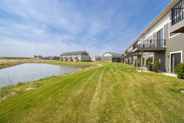 18122 Garland Path, Lakeville, MN 55044 - view of grassy yard with a water view, central AC unit, and a residential view