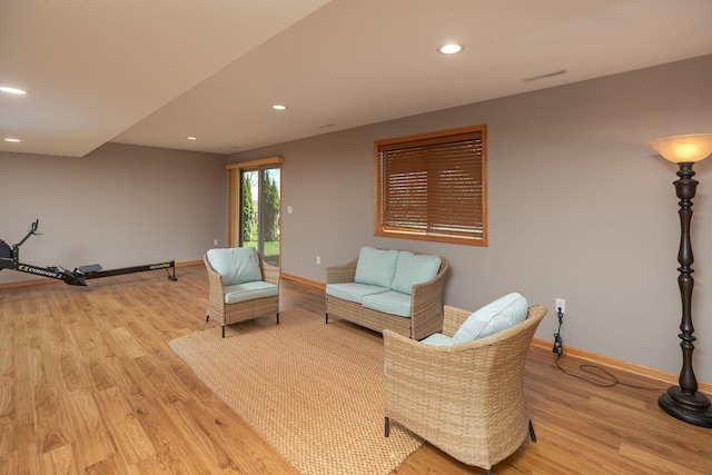 sitting room featuring light wood-style floors, baseboards, and recessed lighting
