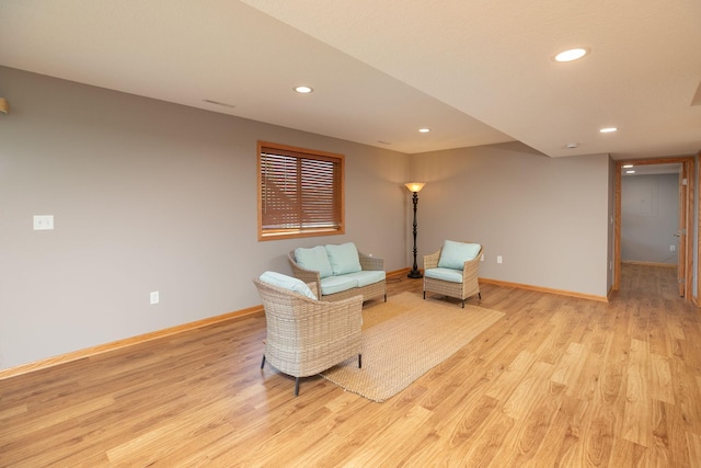 sitting room with light wood-style flooring, baseboards, and recessed lighting