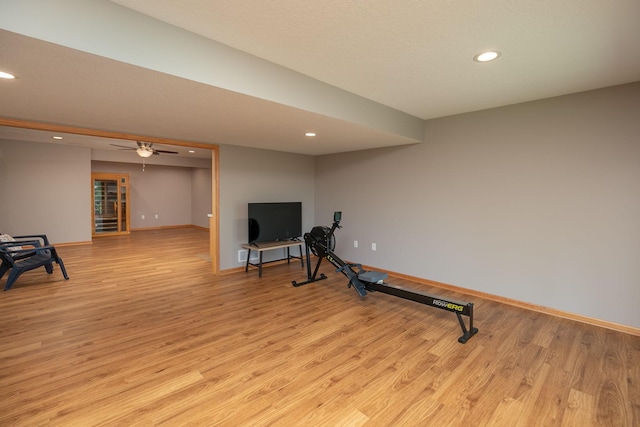 exercise room featuring light wood-style floors, recessed lighting, and baseboards