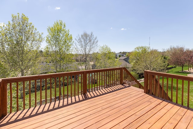 wooden terrace featuring a yard