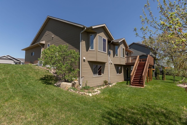 back of house featuring stairs, a deck, and a yard
