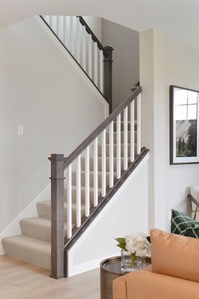 stairway featuring wood finished floors