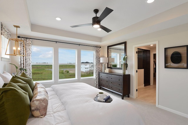 bedroom with recessed lighting, light carpet, baseboards, a ceiling fan, and a walk in closet
