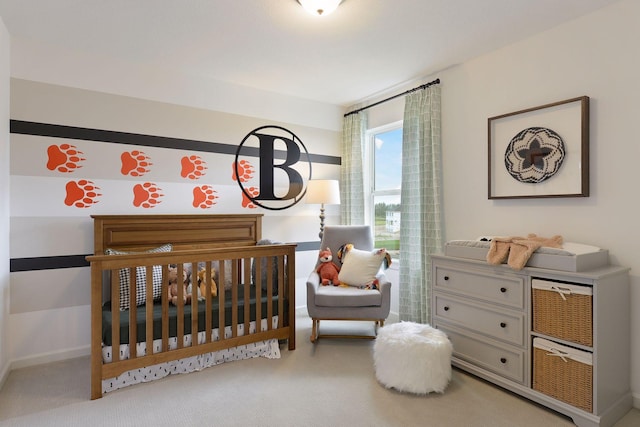 bedroom with carpet floors, a nursery area, and baseboards