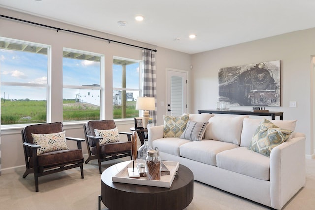 living room featuring light carpet, recessed lighting, and baseboards
