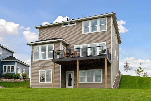rear view of house featuring a lawn and a deck