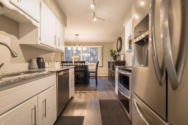 2520 Le Homme Dieu Hts NE Unit 2, Alexandria Twp, MN 56308 - kitchen featuring stainless steel appliances, a sink, dark wood-style floors, white cabinets, and hanging light fixtures