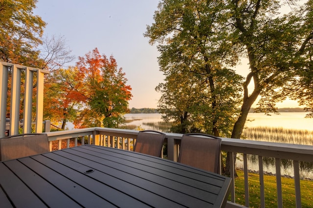 2520 Le Homme Dieu Hts NE Unit 2, Alexandria Twp, MN 56308 - deck at dusk featuring a water view and outdoor dining space
