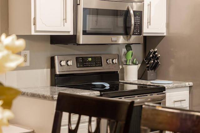 2520 Le Homme Dieu Hts NE Unit 2, Alexandria Twp, MN 56308 - kitchen with stainless steel appliances and white cabinetry