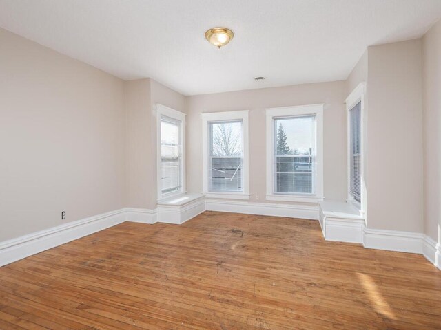 2100 Dupont Ave N, Minneapolis, MN 55411 - empty room with light wood-style floors and baseboards
