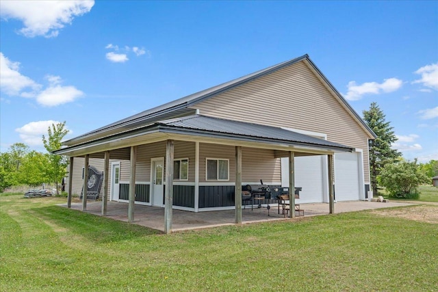1704 156th St, Erin Prairie Twp, WI 54017 - back of property featuring a yard, a detached garage, and a patio area