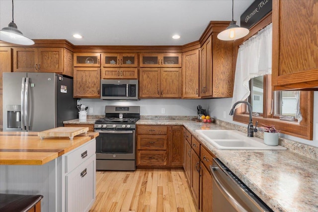 1704 156th St, Erin Prairie Twp, WI 54017 - kitchen featuring appliances with stainless steel finishes, brown cabinets, light wood-style floors, hanging light fixtures, and recessed lighting