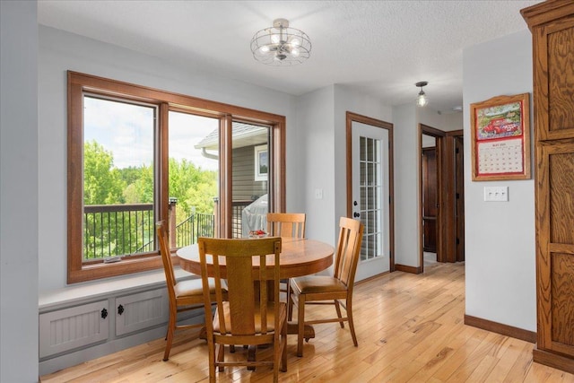 1704 156th St, Erin Prairie Twp, WI 54017 - dining area with light wood-type flooring, a chandelier, and a textured ceiling