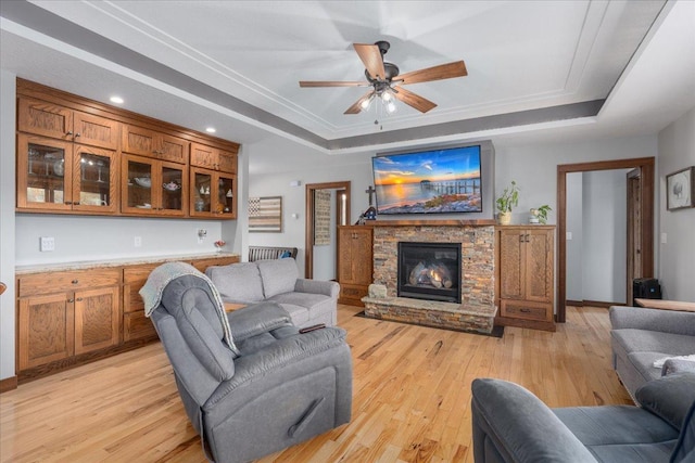 1704 156th St, Erin Prairie Twp, WI 54017 - living room featuring a raised ceiling, light wood-style floors, a stone fireplace, a ceiling fan, and recessed lighting