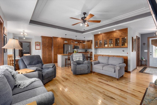 1704 156th St, Erin Prairie Twp, WI 54017 - living room featuring a raised ceiling, light wood-type flooring, and ceiling fan