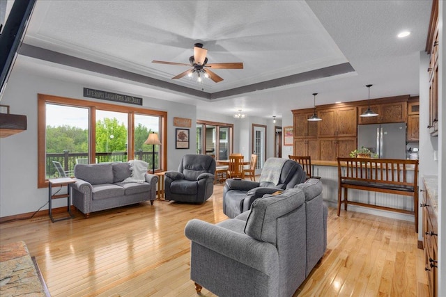 1704 156th St, Erin Prairie Twp, WI 54017 - living area with a raised ceiling, ceiling fan, light wood-type flooring, a textured ceiling, and ornamental molding