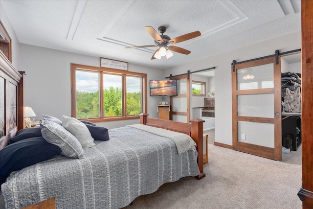 1704 156th St, Erin Prairie Twp, WI 54017 - bedroom with a barn door, carpet floors, a textured ceiling, and a ceiling fan